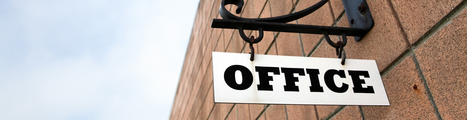 Sign hanging from building that says Office
